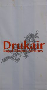 Das Staatswappen ist allgegenwärtig - eine Tüte der königlichen Drukair (Bhutan).